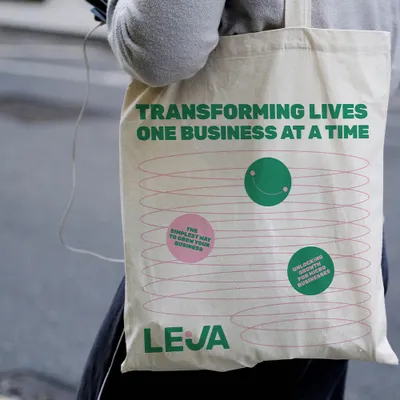 Leja tote bag printed with ‘Transforming lives one business at a time’