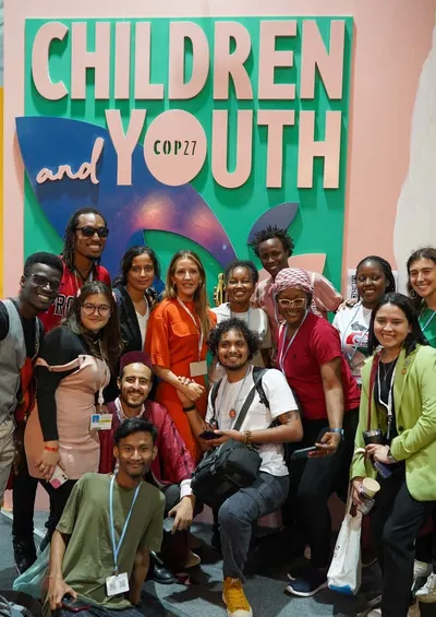 Back cover: young people gathered in front of the Children & Youth sign